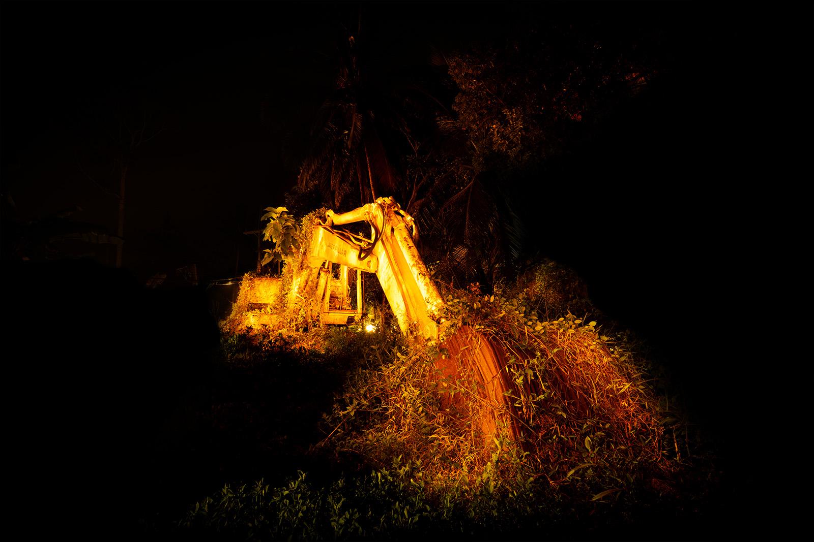 An overgrown digger derelict in Maenam, Thailand.